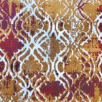 A close-up of the Autumn Horizon Rug showcasing its plush texture and vibrant red, white, and beige patterns against a blurred background. Handmade and available in Mumbai, India.