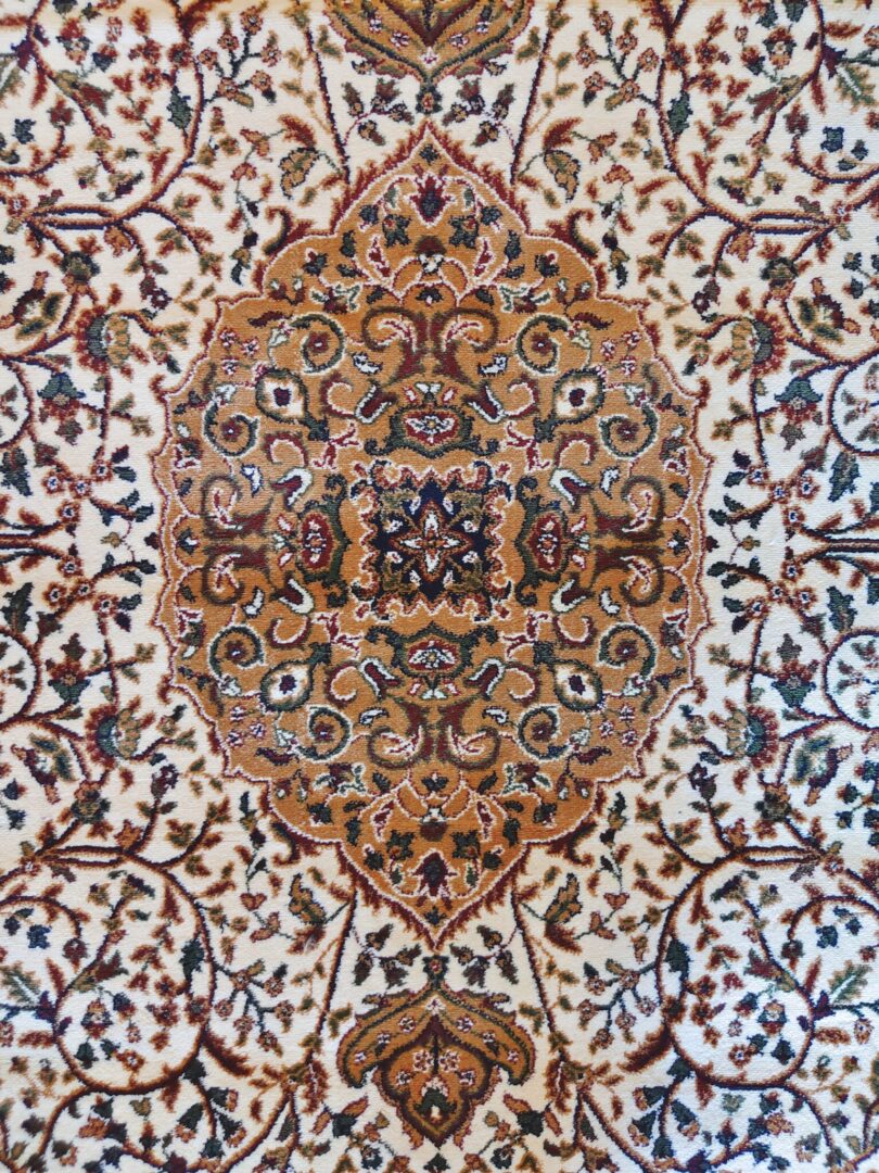 A close-up of the Golden Minaret Rug featuring intricate floral patterns in red, blue, and beige, with a plush texture. Handmade and available in Mumbai, Thane, India.