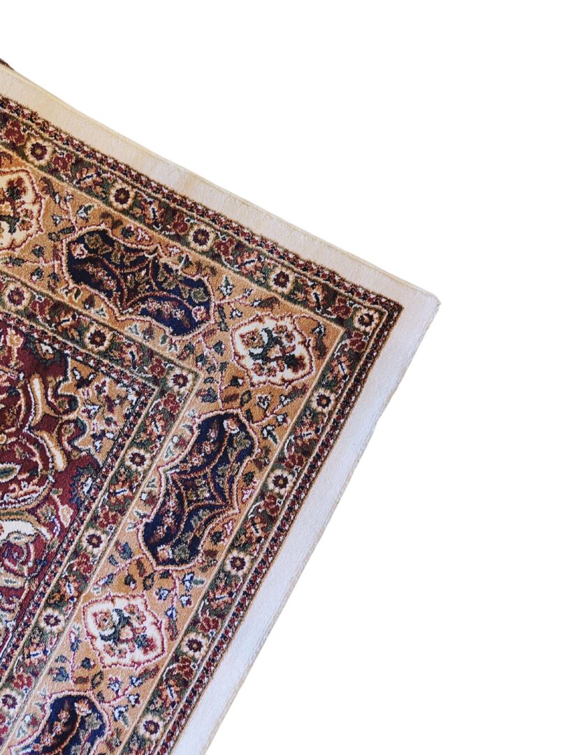 The Golden Minaret Rug features a traditional Persian design with floral and geometric patterns in muted tones, paired with a visible label for quality assurance.