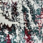 A close-up of the Jingle Frost Rug featuring a modern abstract design with a mix of white, deep red, and dark green colors, with a soft and textured surface.