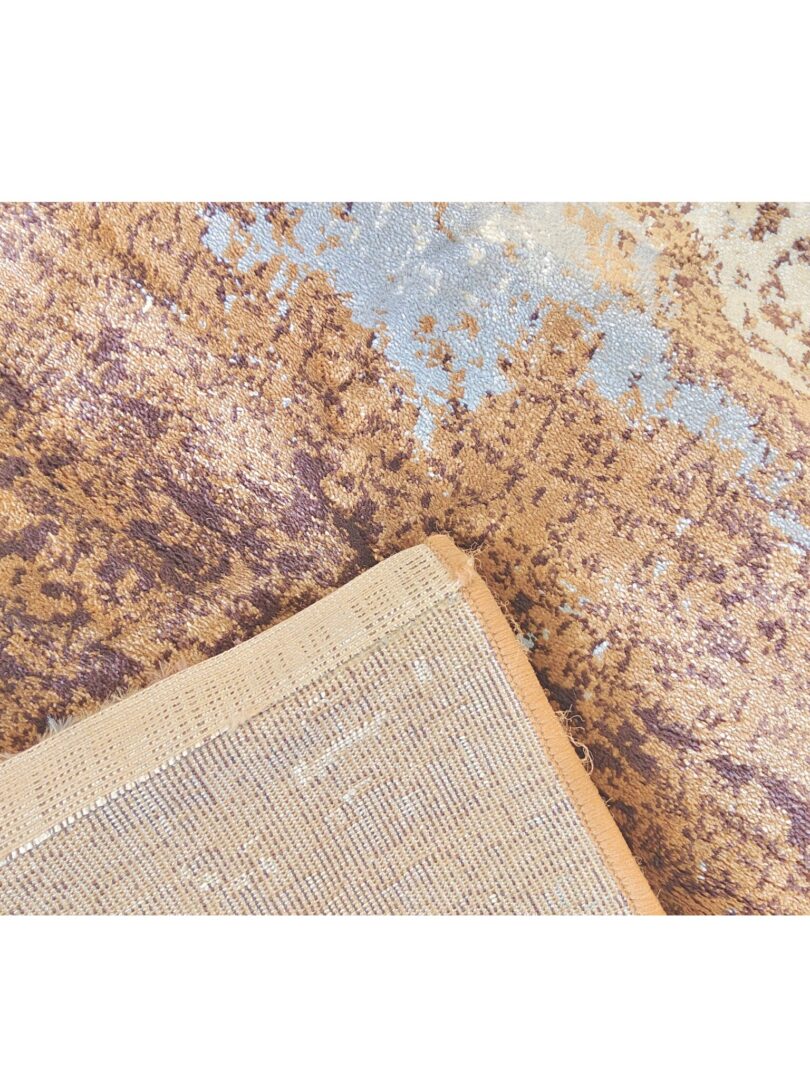 close-up of the Milk Desert Rug with a textured abstract pattern in brown, blue, and white, featuring a beige woven fabric overlay.Handmade and available in Mumbai, Thane, India.