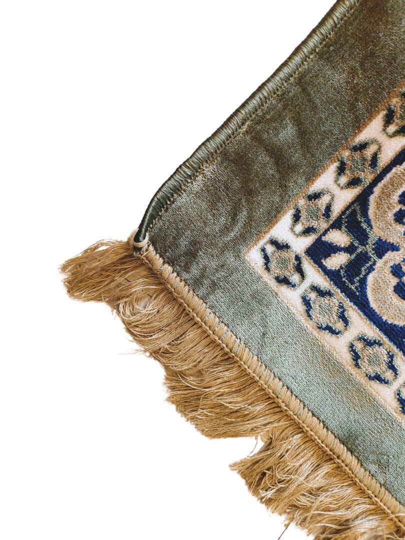 Experience the Olive Dynasty Rug, a handmade Persian-style rug with intricate geometric patterns, vibrant colors, and light brown fringes. Perfect for elegant home decor.
