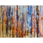A handwoven wool rug with an abstract pattern featuring dark blue, bright orange, red, golden yellow, and beige colors.