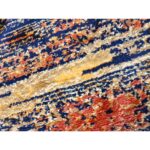 Elevate your space with the Sunrise Rug, a contemporary handtufted wool design featuring abstract vertical streaks in blue, orange, and gray.
