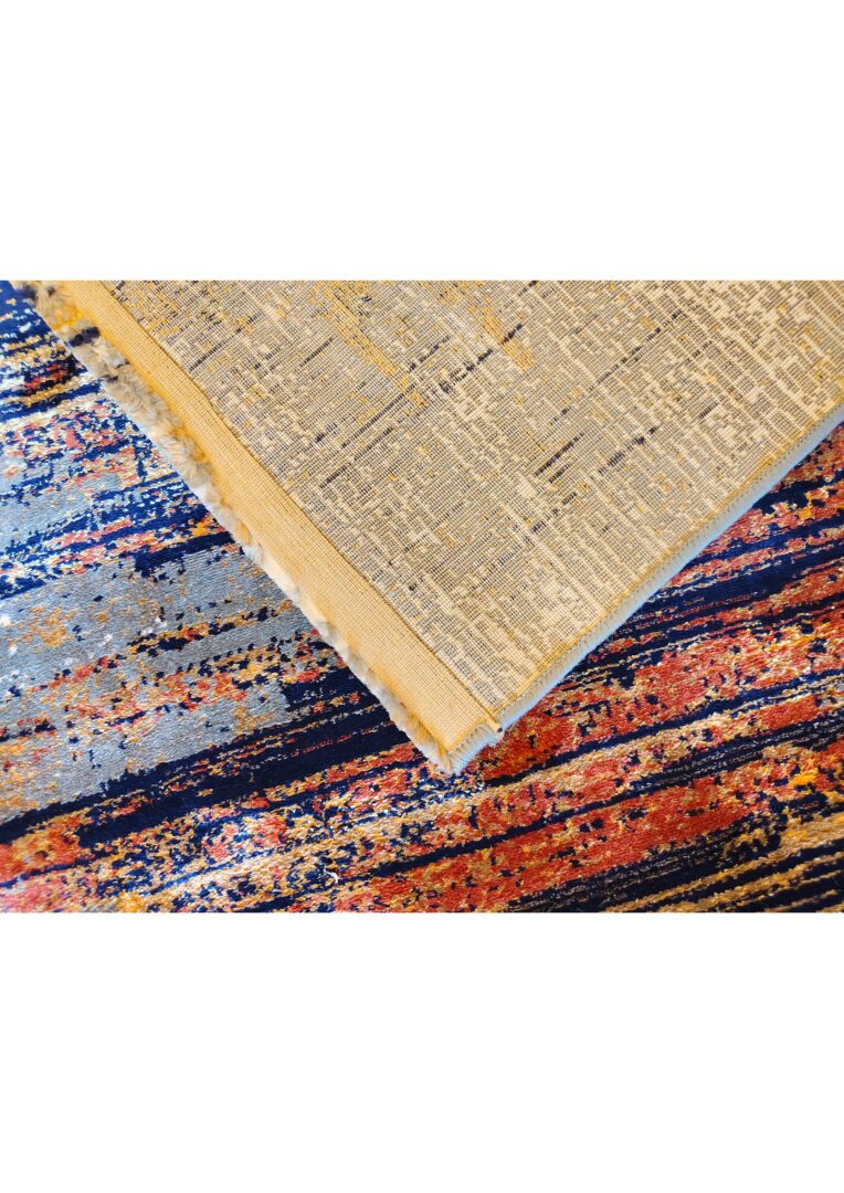 Two overlapping rugs, with the top rug showcasing a beige underside and the bottom rug featuring vibrant horizontal stripes in blue, orange, red, and yellow.