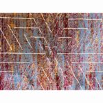 dark abstract rug with intersecting zigzag patterns in blue, brown, and white, placed on a light-colored floor.
